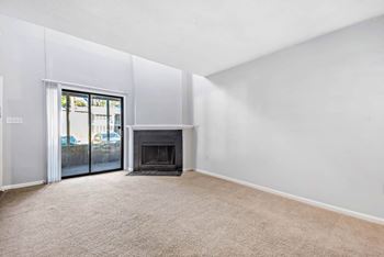 a bedroom with a fireplace and a door to a patio